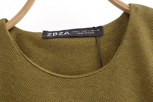 Detail of olive green midi dress featuring a round neck and textured twill fabric surface