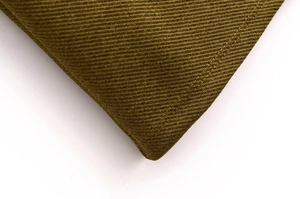 Detailed close-up of olive green heavy twill fabric with precise double-needle stitching