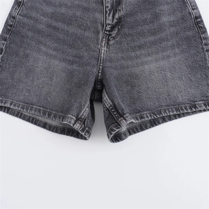 Detalle de pantalones cortos vaqueros gris oscuro con costuras precisas y efecto lavado