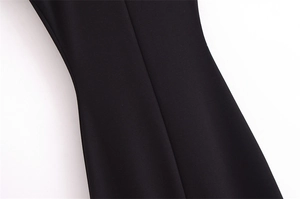Close-up of black sleeveless dress showing high-quality stitching and fabric texture