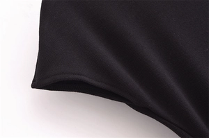 Detailed macro view of black high-density knit fabric with honeycomb texture and neat stitching