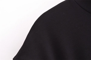 Detail of the high-quality black knitted mesh texture and neat stitching on shoulder area
