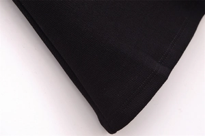 Macro shot of black knitted fabric with detailed double-needle hem stitching finish