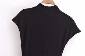 Detail of the high-neck short-sleeve black dress with soft elastic fabric on a wooden hanger