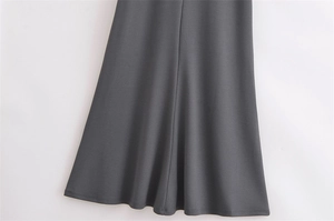 Detailed view of dark grey A-line hemline with fine stitching and soft drape fabric