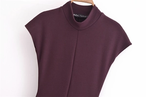 Close-up of deep purple high-neck sleeveless knit dress with vertical seam on wooden hanger