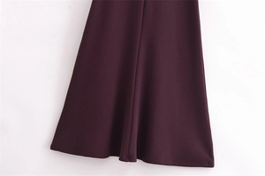 Detailed macro view of the wine red dress hem showing smooth fabric and premium drape
