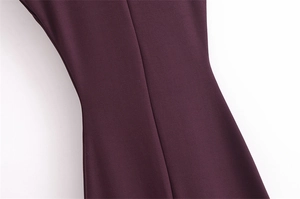 Detailed close-up of dark burgundy woven fabric with central seam and slim fit waistline