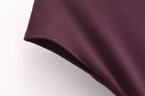 Close-up of high-density knitted fabric showing premium stitching and burgundy texture