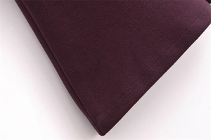 Macro shot of dark purple knitted fabric texture with fine edge stitching detail