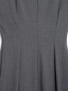 Détail des plis à la taille et texture sergée fine sur une robe midi grise sans manches