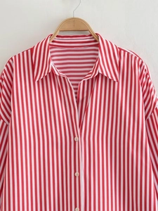 Close-up of red and white vertical striped poplin shirt with white buttons and collar