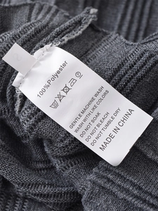 Detailed view of the garment label showing 100% polyester fabric and washing instructions