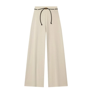 Beige asymmetric high waist wide leg trousers with a gold ring belt and textured fabric