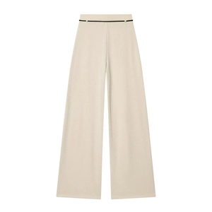 Detail of high-waisted beige wide-leg trousers with slim black belt and knit texture