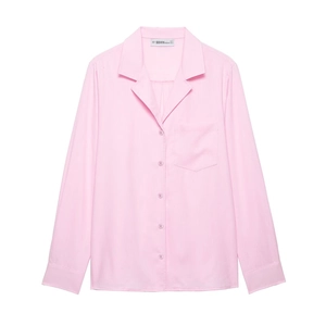 Detailed view of women's pink button-down shirt featuring a classic collar and chest pocket