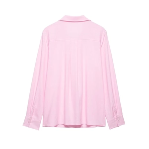 Detail view of pink long-sleeved shirt featuring a back yoke and box pleat design