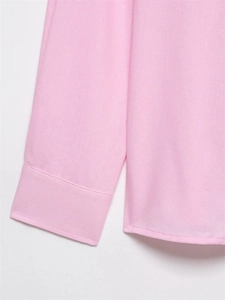 Detailed macro view of smooth pink cotton shirt cuffs and high-quality sewing workmanship