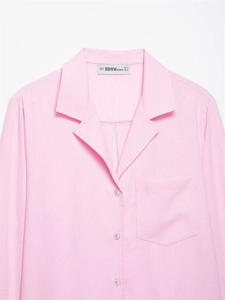Close-up of a pink long sleeve shirt with classic lapel collar and front chest pocket