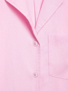 Close-up of pink cotton-linen shirt featuring notch lapel, pocket and color-matched buttons