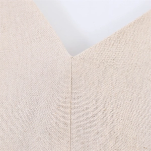 Close-up of V-neckline and textured linen-cotton fabric on a beige casual dress