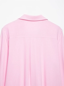Detail of light pink shirt back with classic collar, yoke seam and center pleat design