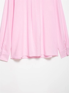 Detail of pink long sleeve shirt showing clean hemline and buttoned cuffs close-up