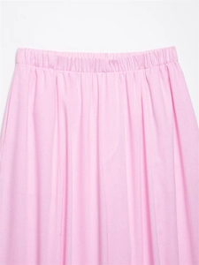 Detailed view of pink high-waist trousers with textured fabric and elastic waistband