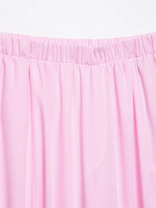 Detail of pink cotton linen pants featuring a wide elastic waistband and fine pleated texture