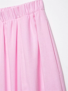 Detail of pink garment featuring elastic high waistband and textured pleated fabric design