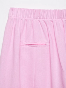 Detail view of pink casual pants with elastic waistband and high-quality welt pocket