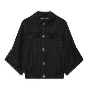 Women's safari style black shirt jacket with golden buttons and textured glossy fabric