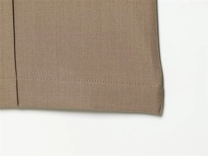 Close-up of khaki twill fabric trousers showing detailed stitching and side seam textures