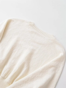 Close-up of cream white knit sweater showing soft mohair texture and ribbed round neckline