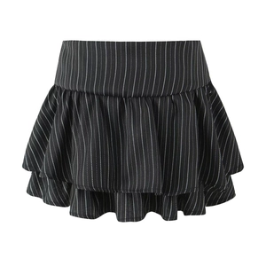 Close-up detail of double-layered ruffle hem on black pinstripe pleated mini skirt