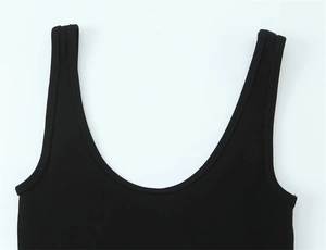 Detailed close-up of black ribbed knit cotton fabric on a slim fit wide strap tank top