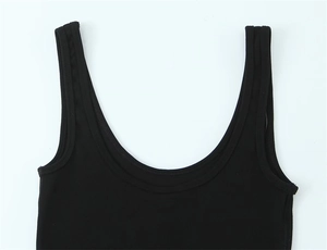 Macro shot of black ribbed cotton texture and wide strap on minimalist scoop neck tank top