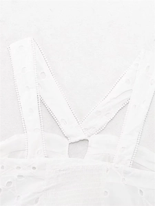 Detail of white Broderie Anglaise lace camisole showing floral cutouts and embroidery