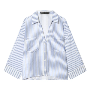 Women's loose blue and white striped button-up shirt with front pockets and oversized fit