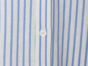 Detailed close-up of blue and white vertical striped fabric with a white button