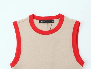 Close-up of contrast red ribbed neckline and brand label on beige sleeveless top