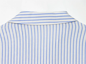 Close-up of the lapel collar and fine stitching on a blue and white striped shirt