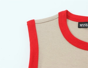Detail of khaki knit shirt with contrast red ribbed trim on collar and shoulder seam