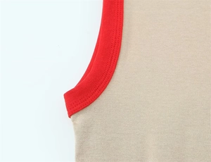 Detailed macro view of khaki knit top with contrast red ribbed trim on armhole