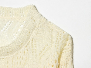 Close-up of beige diamond hollow knit texture and ribbed neckline on summer sweater