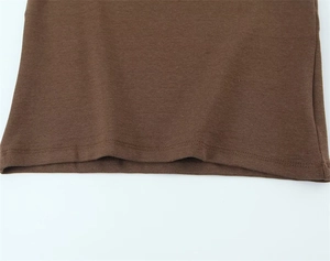 Detailed view of brown knit t-shirt hem featuring high-quality double-needle stitching