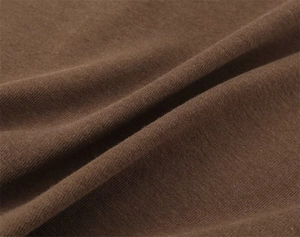 Close-up of the breathable dark brown knit fabric showing soft texture and fine stitching