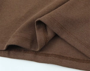 Macro detail of dark brown knit fabric with double-needle stitching and smooth hemline