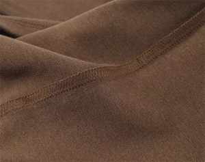 Close-up detail of reinforced double stitching on high-quality brown knit t-shirt fabric