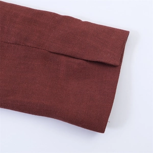 Detailopname van de wijnrode double-breasted jas met hoogwaardige twill-textuur